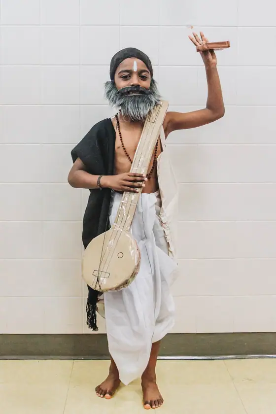 A saint of India, with staff and drum.